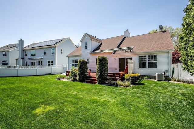 rear view of house featuring a lawn, a fenced backyard, central air condition unit, and a deck
