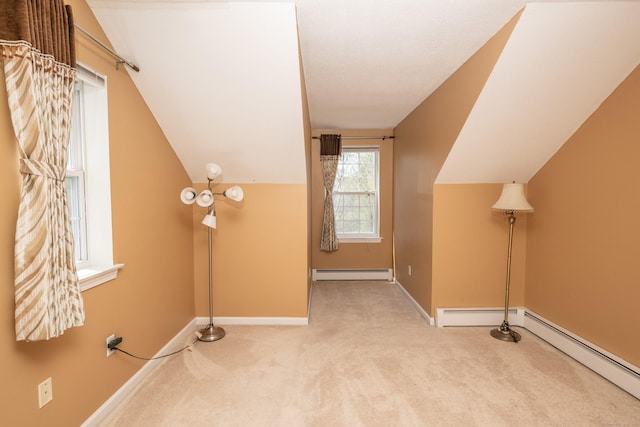 bonus room featuring vaulted ceiling, baseboards, carpet, and a baseboard heating unit