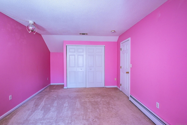 unfurnished bedroom featuring a baseboard radiator, carpet, a closet, and visible vents
