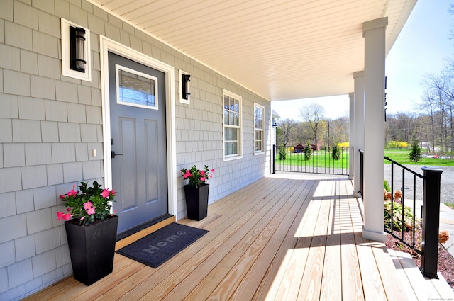 wooden terrace featuring covered porch