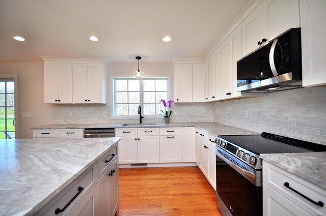 137 Buell Rd, Litchfield, CT 06759 - kitchen with stainless steel appliances, a sink, white cabinetry, light stone countertops, and recessed lighting