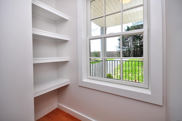 interior space featuring baseboards and wood finished floors