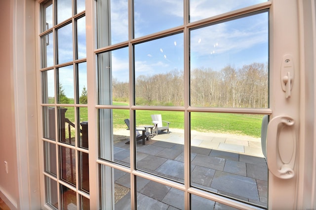 doorway to outside featuring stone tile flooring