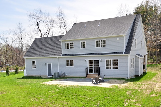 back of property featuring roof with shingles, entry steps, cooling unit, a lawn, and a patio