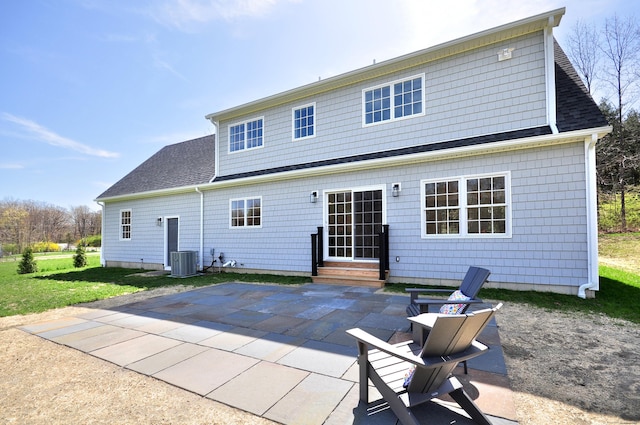 rear view of house featuring a patio, central AC, a shingled roof, and entry steps