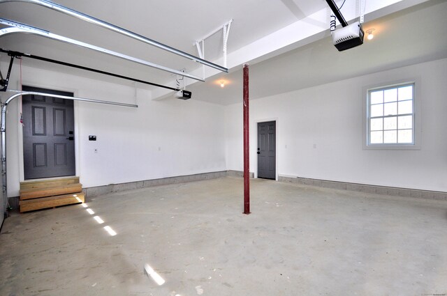 garage with baseboards and a garage door opener