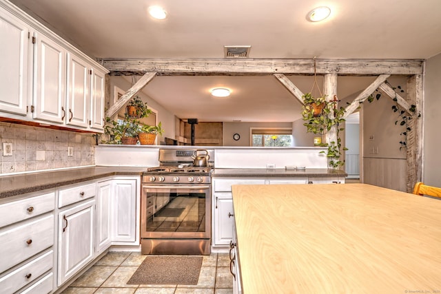 104 S St, Morris, CT 06763 - kitchen with backsplash, stainless steel gas stove, white cabinetry, and visible vents