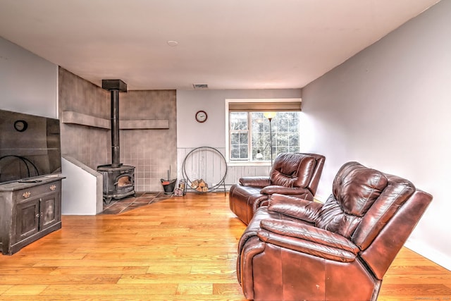 104 S St, Morris, CT 06763 - living room with a wood stove, visible vents, and wood finished floors