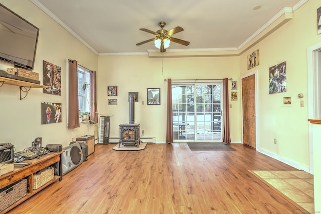 104 S St, Morris, CT 06763 - living room with a baseboard heating unit, wood finished floors, a wood stove, crown molding, and a ceiling fan
