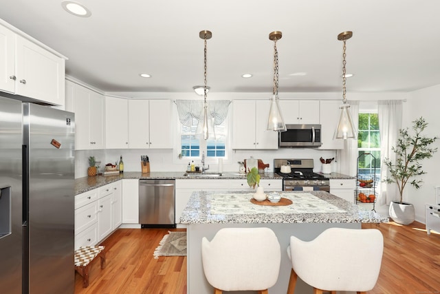 26 Greenwood Dr, Prospect, CT 06712 - kitchen with a sink, light wood-style flooring, a center island, stainless steel appliances, and recessed lighting