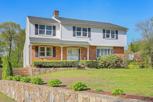 15 Kingsbury Rd, Norwalk, CT 06851 - view of front of home featuring brick siding, a front yard, a chimney, and covered porch