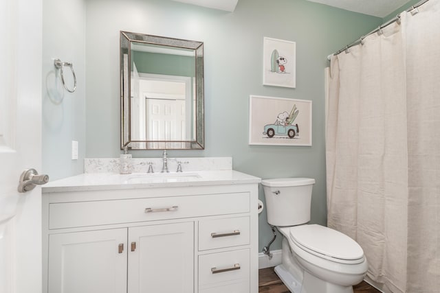 full bathroom featuring vanity, baseboards, toilet, and wood finished floors