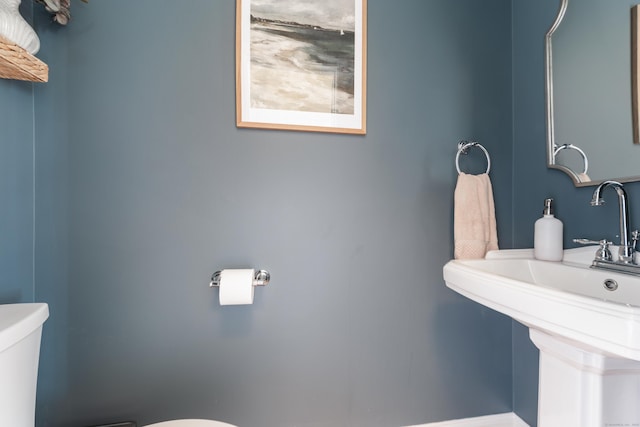 bathroom with toilet and a sink