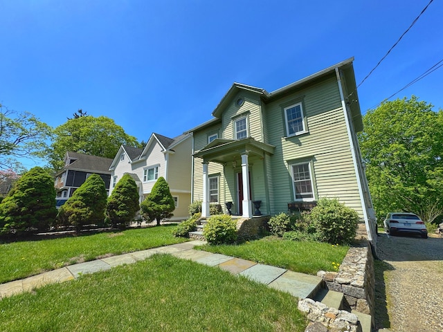 traditional-style home with a front yard