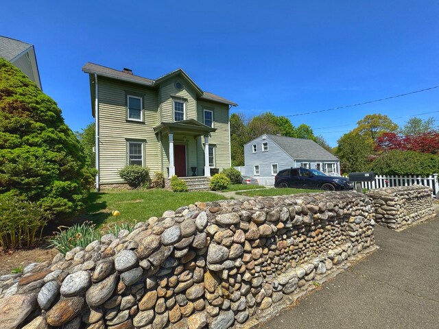 10 Ells St, Norwalk, CT 06850 - traditional-style home featuring a chimney and fence