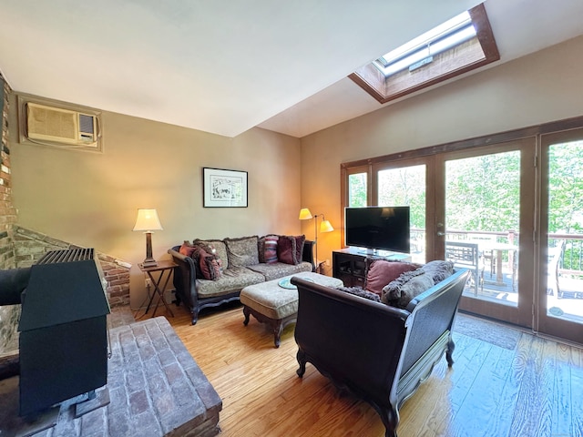 living room with french doors, a wealth of natural light, a skylight, and light wood-type flooring