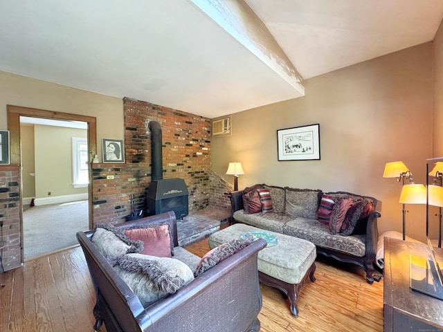 living room featuring a wood stove and wood finished floors