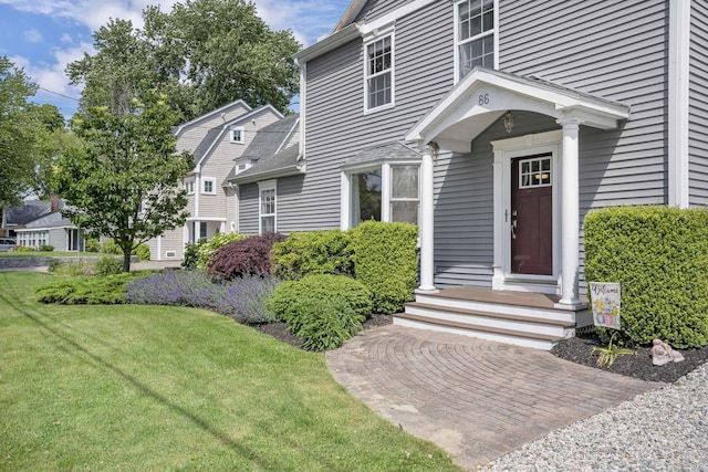doorway to property featuring a lawn