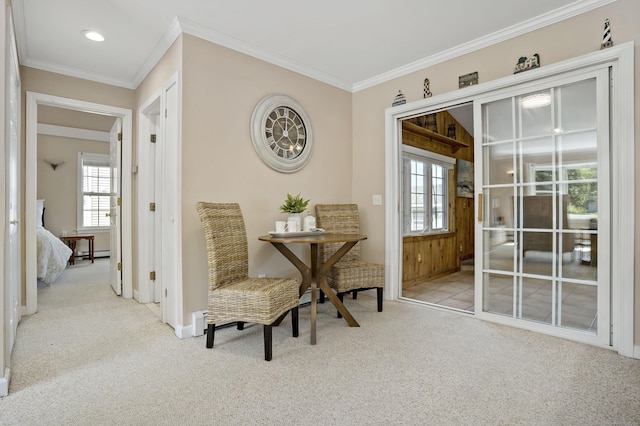 carpeted dining room featuring baseboards, ornamental molding, and a baseboard radiator