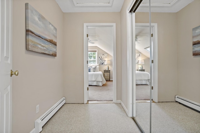 hall with a baseboard radiator, a baseboard heating unit, and vaulted ceiling