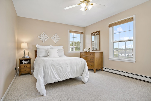 bedroom with baseboards, a baseboard radiator, carpet, and a ceiling fan