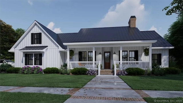 17A Old Stonington Rd, Stonington, CT 06378 - modern inspired farmhouse featuring board and batten siding, a standing seam roof, a chimney, covered porch, and a front lawn