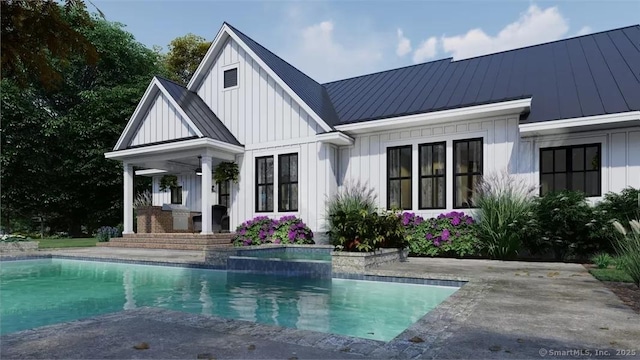 17A Old Stonington Rd, Stonington, CT 06378 - rear view of property with board and batten siding, a standing seam roof, metal roof, and an outdoor pool