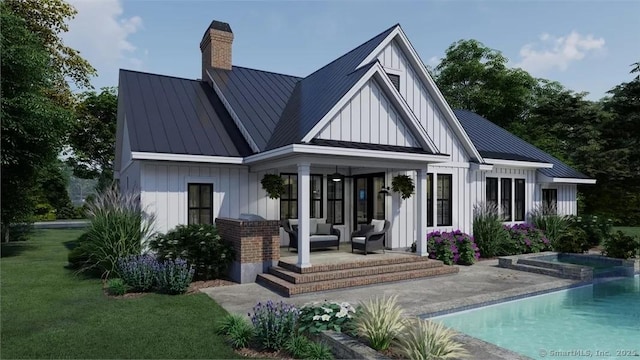 17A Old Stonington Rd, Stonington, CT 06378 - rear view of property featuring a standing seam roof, board and batten siding, a patio, and an outdoor living space