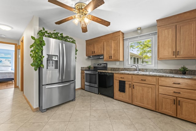 21 Roosevelt Blvd, Enfield, CT 06082 - kitchen with stainless steel appliances, under cabinet range hood, a sink, light tile patterned flooring, and brown cabinetry