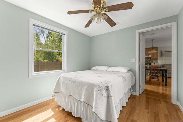 21 Roosevelt Blvd, Enfield, CT 06082 - bedroom featuring wood finished floors, a wall mounted AC, baseboards, and ceiling fan