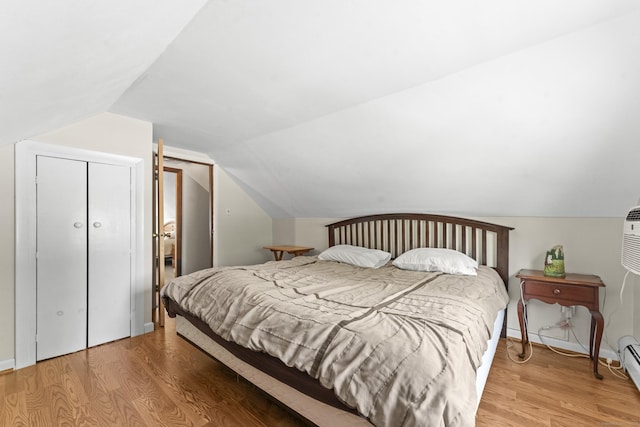 21 Roosevelt Blvd, Enfield, CT 06082 - bedroom with light wood-type flooring, vaulted ceiling, a baseboard heating unit, and a closet