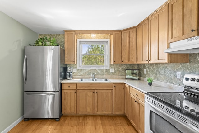 21 Roosevelt Blvd, Enfield, CT 06082 - kitchen with stainless steel appliances, under cabinet range hood, decorative backsplash, light wood-style floors, and a sink