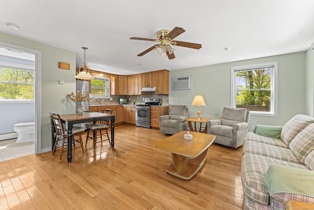 21 Roosevelt Blvd, Enfield, CT 06082 - living area with healthy amount of natural light, light wood-style flooring, ceiling fan, and baseboards