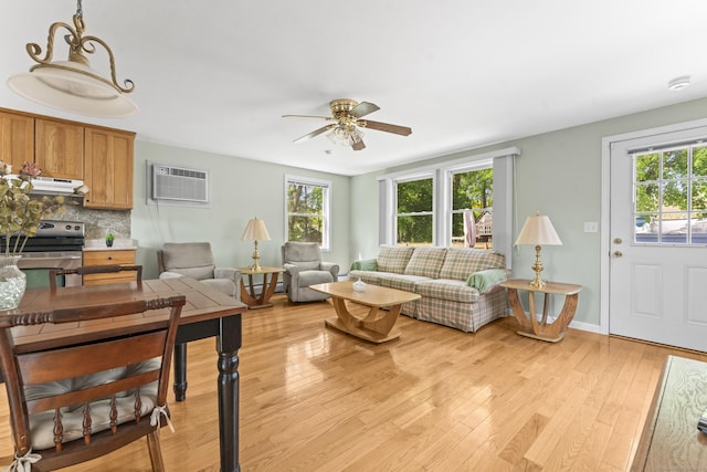 21 Roosevelt Blvd, Enfield, CT 06082 - living room featuring a wall mounted AC, plenty of natural light, ceiling fan, and light wood-style floors