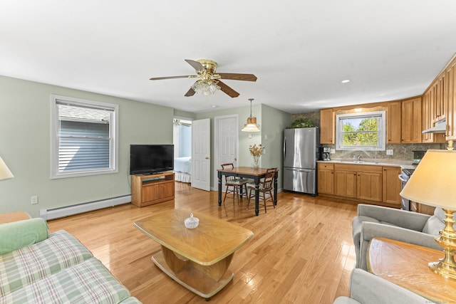 21 Roosevelt Blvd, Enfield, CT 06082 - living room with baseboard heating, a ceiling fan, and light wood-type flooring