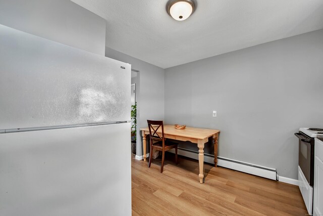 270 S Windham Rd Apt 63, Windham, CT 06226 - dining area with baseboards, light wood finished floors, and baseboard heating