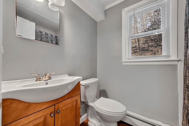 bathroom featuring a healthy amount of sunlight, crown molding, vanity, a baseboard radiator, and toilet