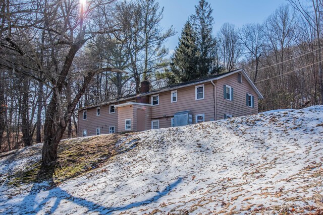 270 S Windham Rd Apt 63, Windham, CT 06226 - snow covered rear of property with a chimney