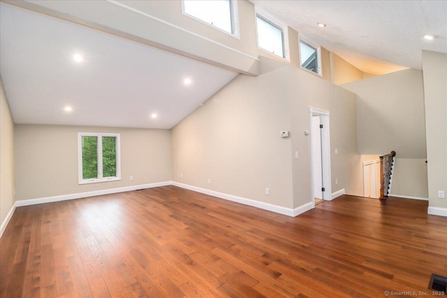bonus room with recessed lighting, baseboards, high vaulted ceiling, and wood finished floors