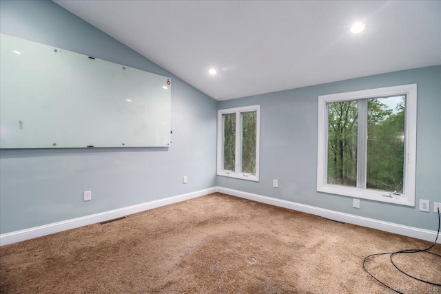 spare room featuring lofted ceiling, recessed lighting, carpet, baseboards, and visible vents