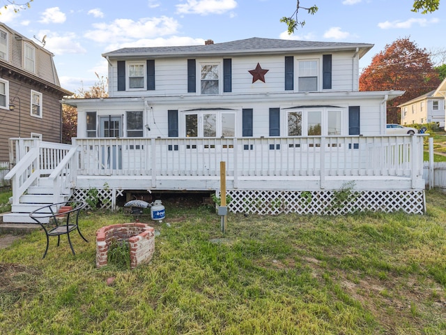 view of front facade featuring a front lawn and a deck