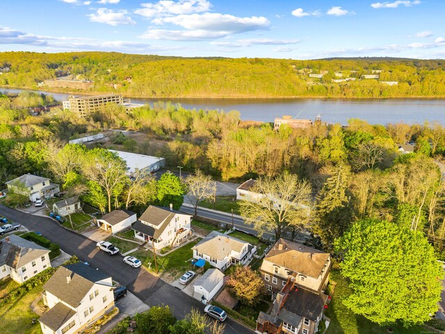 birds eye view of property with a water view and a forest view