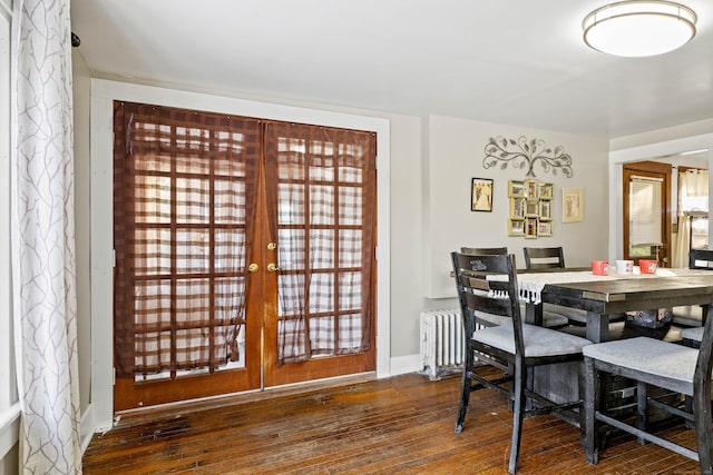 dining space featuring baseboards, french doors, radiator, and hardwood / wood-style floors