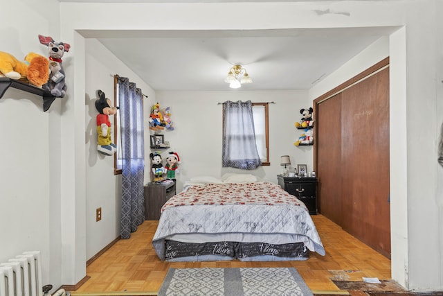 bedroom with radiator and a closet