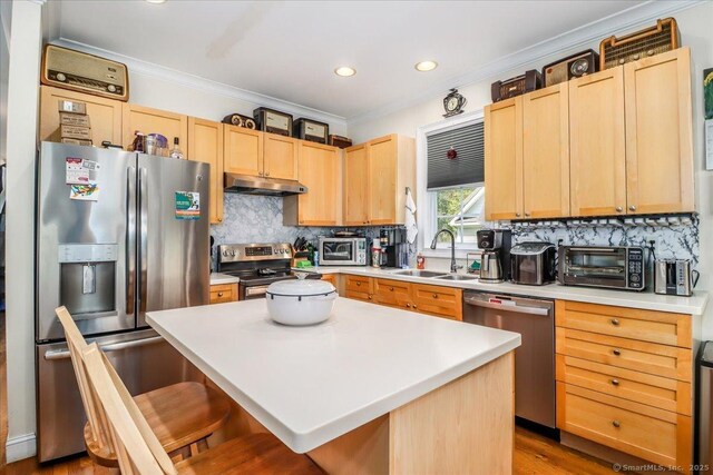 21 Woodcrest Ln Unit 21, Danbury, CT 06810 - kitchen featuring crown molding, appliances with stainless steel finishes, a sink, light brown cabinets, and under cabinet range hood