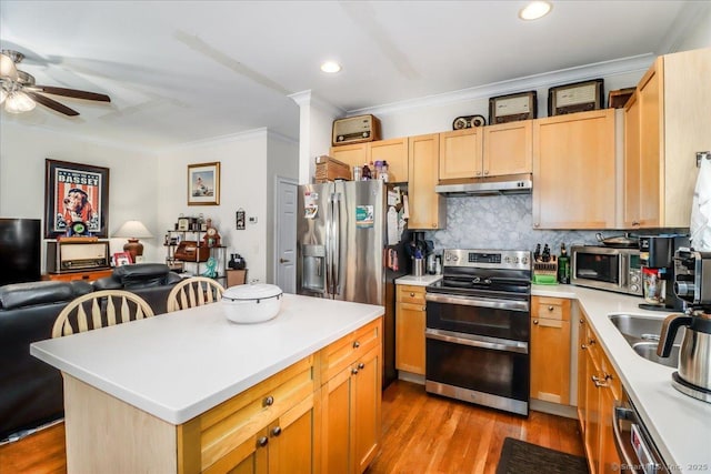 21 Woodcrest Ln Unit 21, Danbury, CT 06810 - kitchen with crown molding, open floor plan, ceiling fan, under cabinet range hood, and appliances with stainless steel finishes
