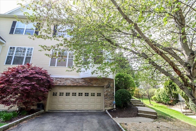 21 Woodcrest Ln Unit 21, Danbury, CT 06810 - view of side of home with an attached garage, driveway, and stone siding