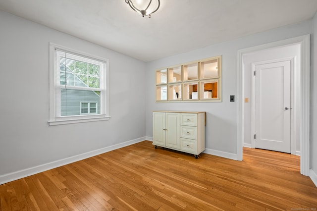 interior space with baseboards and light wood-style floors