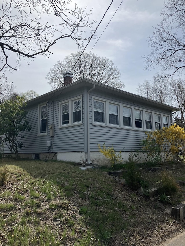 view of side of home featuring a chimney
