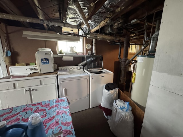 washroom featuring water heater, cabinet space, and washer and dryer